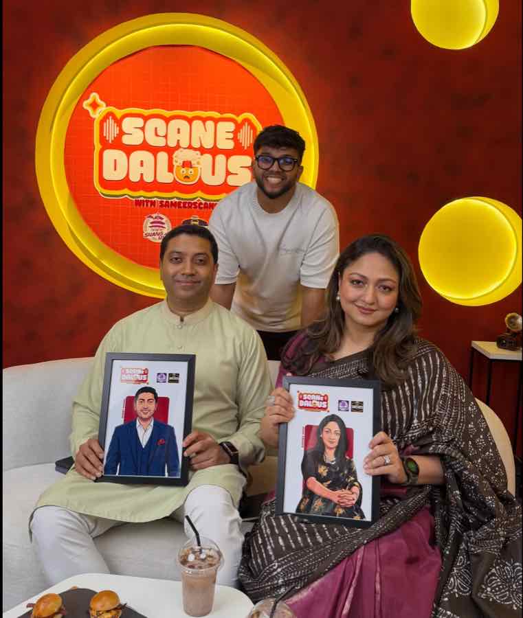 Bobby Hajjaj and his wife seated with framed illustrated portraits of themselves, with Sameer Scane standing behind them under the Scane Dalous logo.