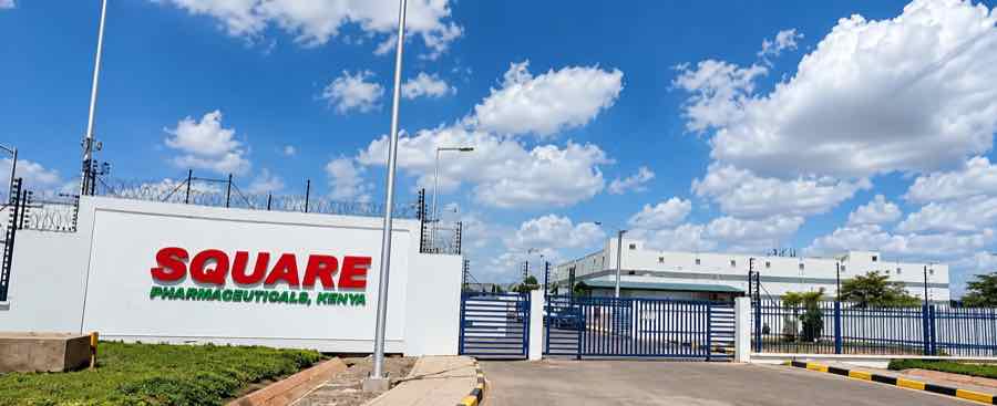 The gated entrance of Square Pharmaceuticals' plant in Kenya, with a wall sign reading Square Pharmaceuticals, Kenya, under a blue sky.